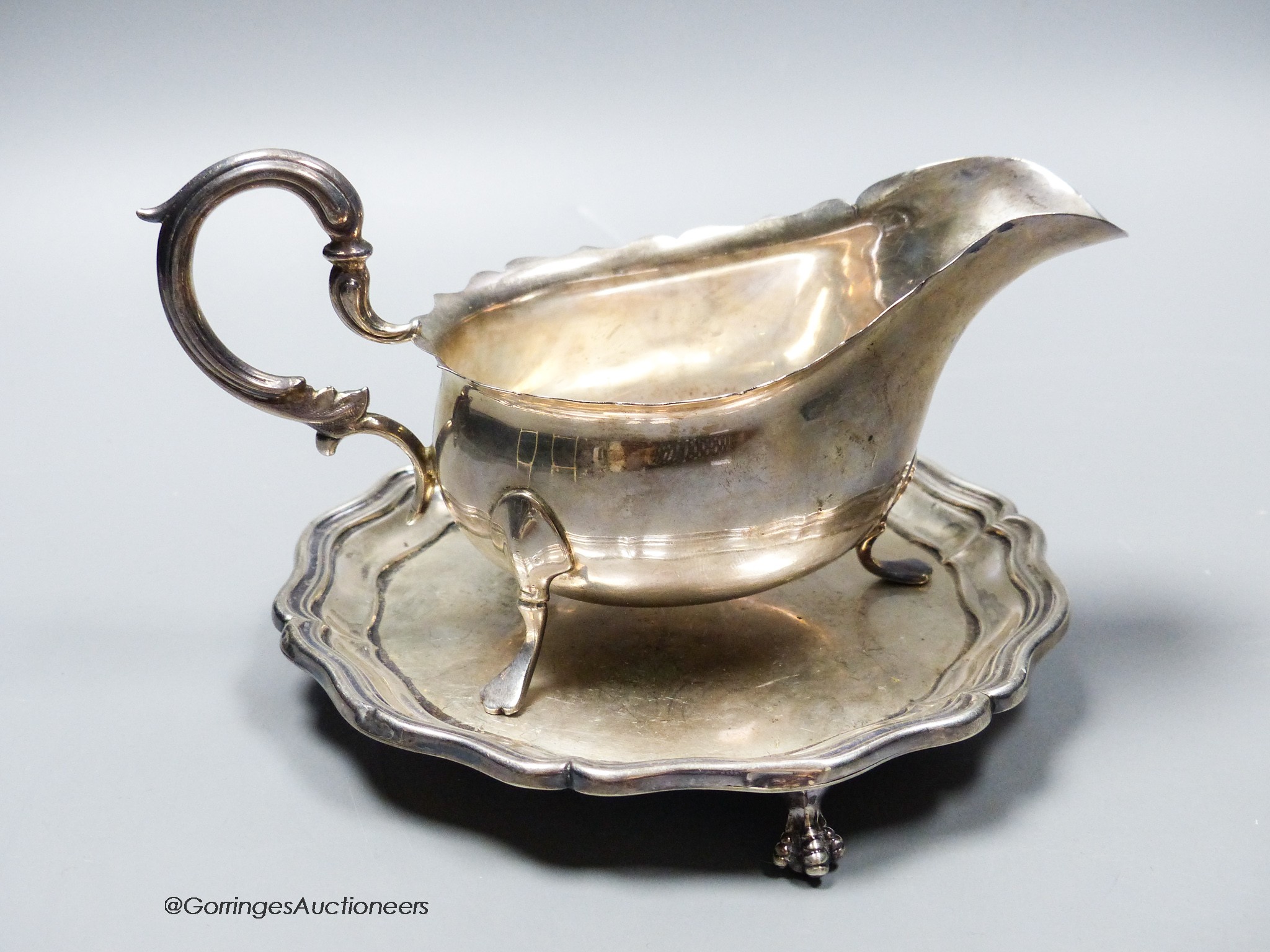 An Edwardian silver small waiter, 14.7cm, Sheffield, 1901 and a later silver sauceboat, 10.5oz.